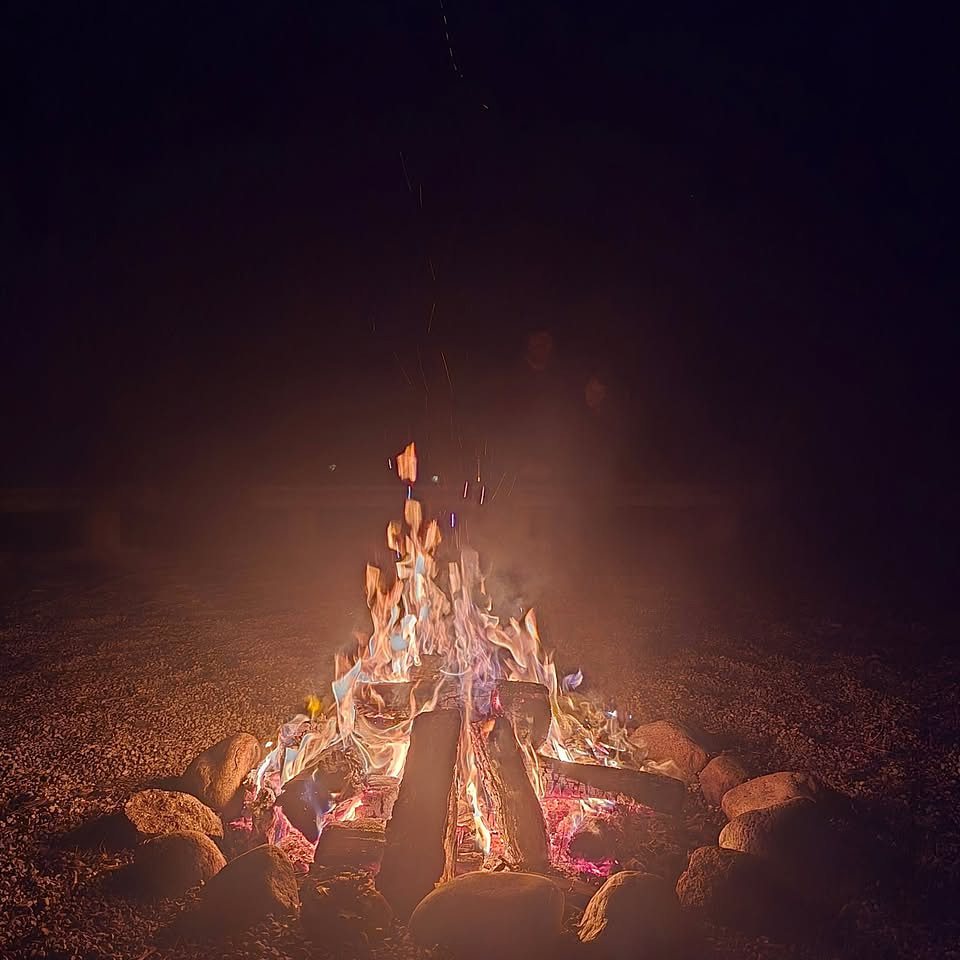 Families gathered around the fire at the end of the Lantern Walk