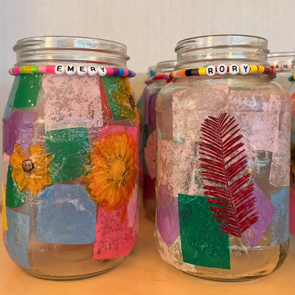 Decorated glass jar lanterns students made in class before the walk